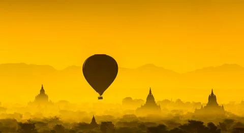 Balloon over plain of Bagan in misty morning, Myanmar Stock Photos