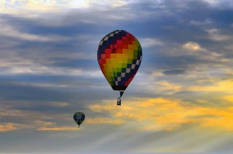 Balloon pair in a sunset sky Stock Photos