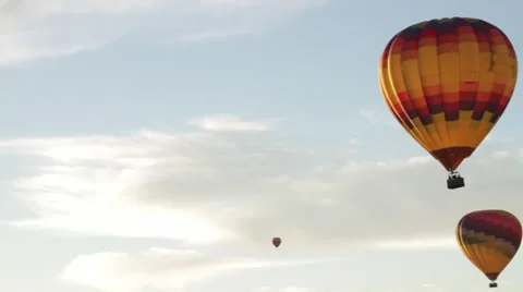 Balloon pan right left 2 fire hot air flying through sky on california morning Stock Footage 35402781