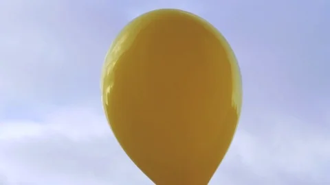 Balloon Pop. Yellow balloon on blue sky background. Stock Footage 84723448