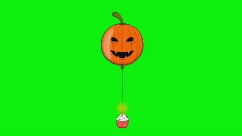 A balloon with pumpkin on it flying through the air and an orange ' s side Stock Footage 345497056