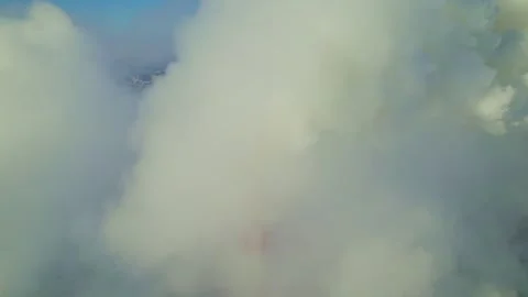 Balloon rising through thick clouds in picturesque landscape at sunrise Stock Footage 312856224