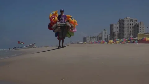 A balloon seller on the beach Stock Footage 148626760