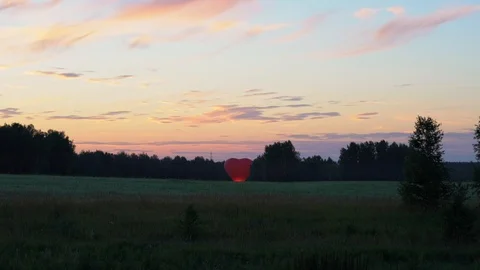 A balloon in the shape of a heart stands on the ground and glows. 库存影片 93268993