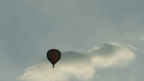 Balloon takes off. Cloud behind. Multicolored balloon. Flying up Stock Footage 172007780