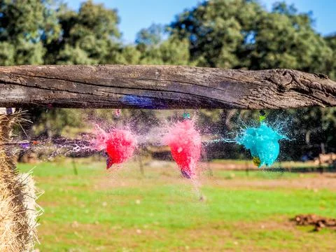 Balloons exploding when hit by an arrow. Closeup hi-speed shot Stock Photos