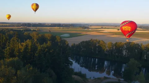 Balloons float over a river Stock Footage 56435616
