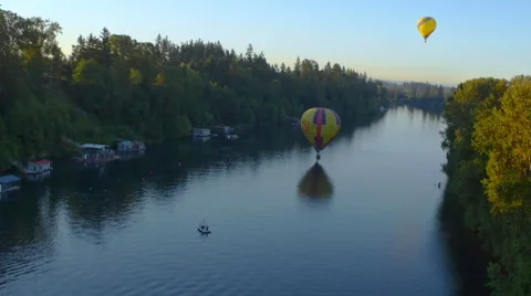 Balloons float over a river Stock Footage 56450232