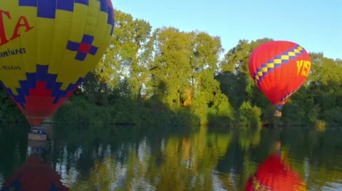 Balloons floating right on top of the water Stock Footage 56460156