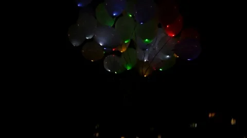 Balloons fly into the night sky Stock Footage 75538072