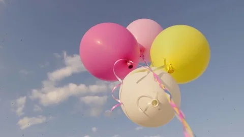 Balloons on a green meadow at sunset. Concept - lightness and freedom of Stock Footage 76156878