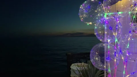 Balloons with neon light on the background of a night seascape Video stock 157035537