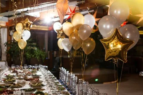 Balloons in the restaurant on a holiday table setting Stock Photos