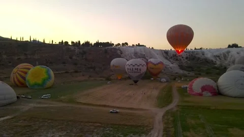 Balloons take off against the background of the rising sun in Turkey Stock Footage 214869526