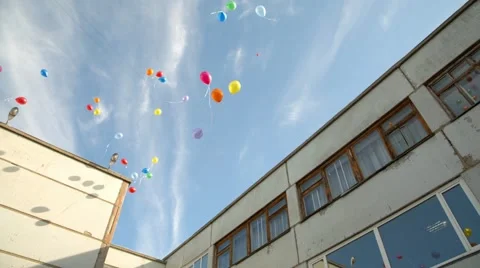 Balloons take off into the sky on a school celebration Stock Footage 45863608