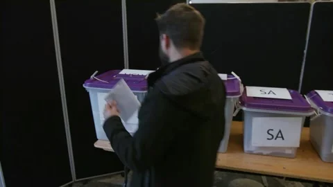 Ballot boxes marked with Australian state names at the polling place Stock Footage 345299082