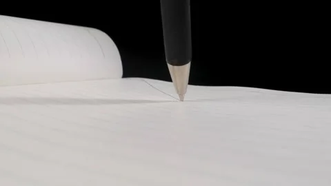 A ballpoint pen draws on a sheet of paper in a Notepad. Black background. Black  Видео 144907236
