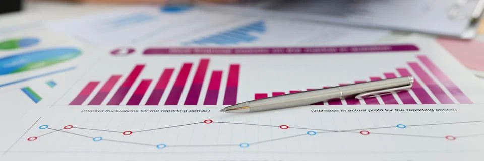 Ballpoint pen lying on documents with graphs and diagrams closeup Stock Photos