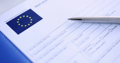 Ballpoint pen lying on table with schengen visa application 4k movie slow motion Stock Footage 257668614