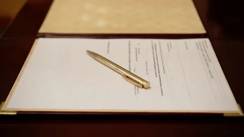 The ballpoint pen rests on the table on top of the document 스톡 동영상 136557189