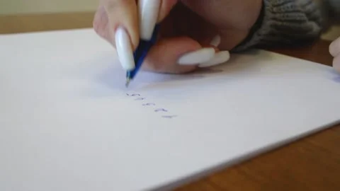 A ballpoint pen writes numbers on a sheet. Writing numbers from 1 to 12 on paper Video stock 196099854