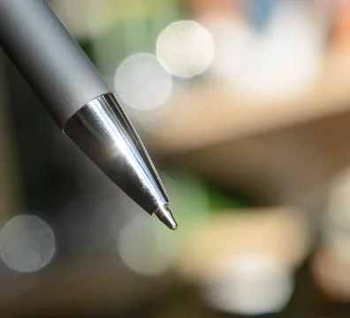 Ballpoint silver pen close-up on a blurred background. Concept - sign documents 写真素材