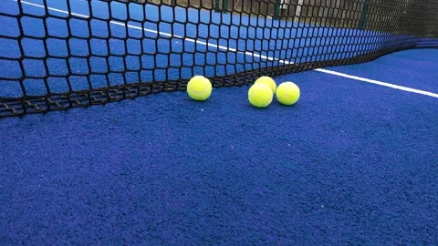 Balls bouncing on a blue paddle tennis court Stock Footage 170452792