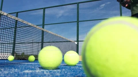 Balls close to the net on a blue paddle court and one bouncing, surface lev.. 스톡 동영상 311758911