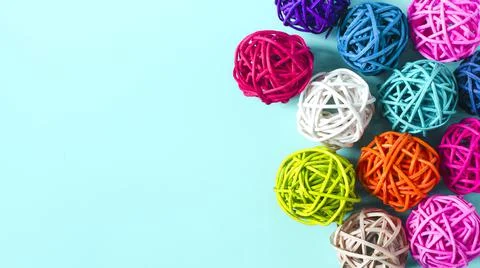Balls of colored threads on an azure background. 스톡 사진