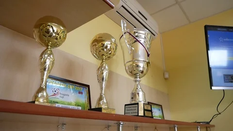 Balls, cups and awards are displayed on shelves Stock Footage 126089400