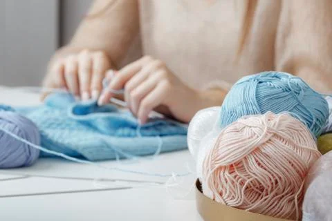 Balls for knitting on the background of hands Stock Photos