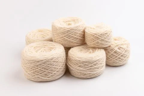 Balls of light woolen thread on white background. natural wool. knitting. bac Stock Photos