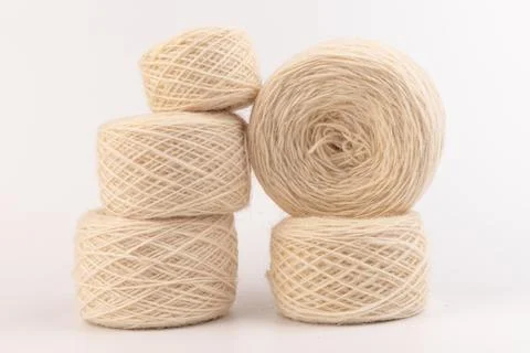 Balls of light woolen thread on white background. natural wool. knitting. bac Stock Photos