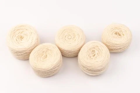 Balls of light woolen thread on white background. natural wool. knitting. bac Stock Photos