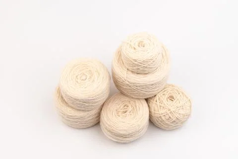 Balls of light woolen thread on white background. natural wool. knitting. bac Stock Photos