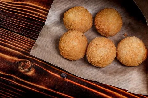 Balls of mashed potatoes are lying on paper. Close-up. Stock Photos