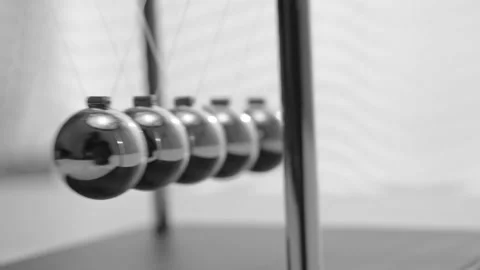 The Balls Of A Newton’s Cradle Colliding In Slow Motion Video stock 234979973