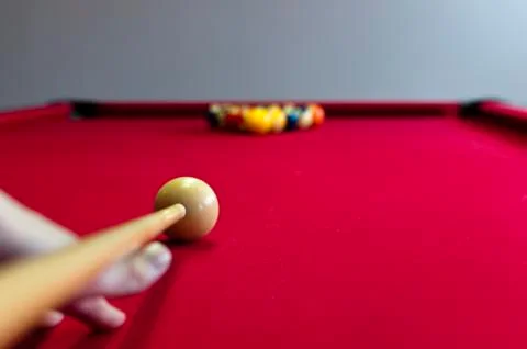 Balls on a red pool table with player Stock Photos