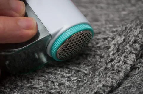 Balls shaving on grey woolen pullover Stock Photos