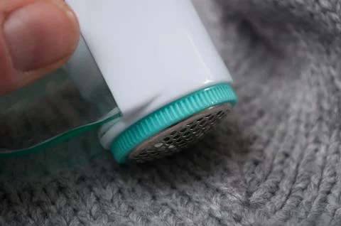 Balls shaving on woolen pullover Stock Photos