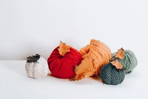 Balls of wool for knitting in autumn colors on a white background Stock Photos