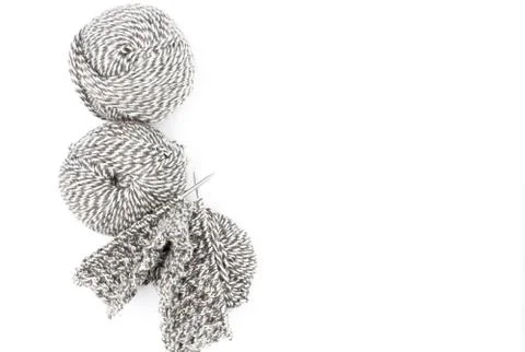 Balls of yarn and started knitting cloth on knitting needles. Stock Photos