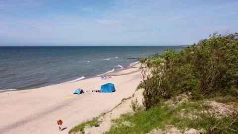 Baltic coast in summer, drone view of people walking along the beach Video stock 197549286