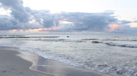 Baltic Sea, breakwaters and dramatic sky at sunset Stock Footage 37625606