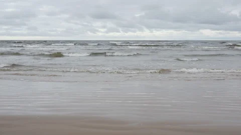 Baltic Sea waves rolling on wet sandy beach in Jurmala Latvia resort town Stock Footage 325973665