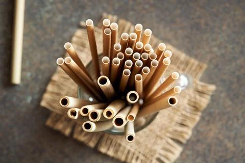 Bamboo and paper straws on a table - zero-waste or ecology concept Stock Photos