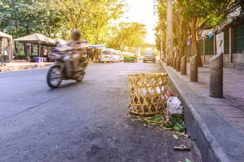 Bamboo basket use for keep garbage at streetside. Stock Photos