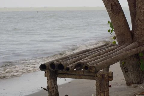 Bamboo bench on the beach Stock Photos