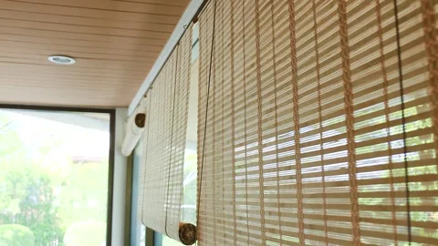 Bamboo blinds with warm sunlight through window. Natural light creates Stock Footage 328259032