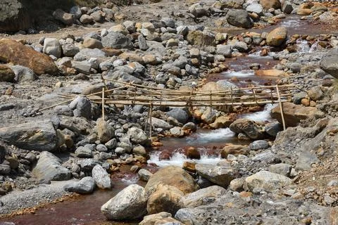 Bamboo bridge over high current himalyan river . Stock Photos